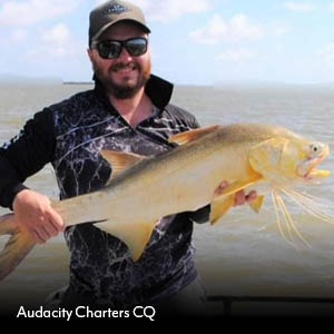 Audacity Charters CQ guest holding a king threadfin salmon