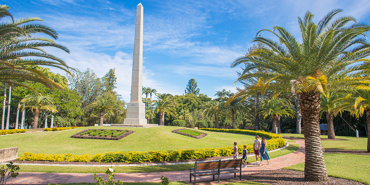 a family walking past the ANZAC cenotaph at rockhampton botanic gardens