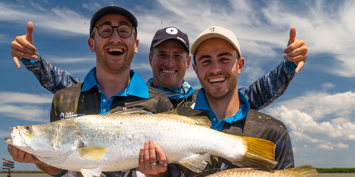 Two men holding a barramundi