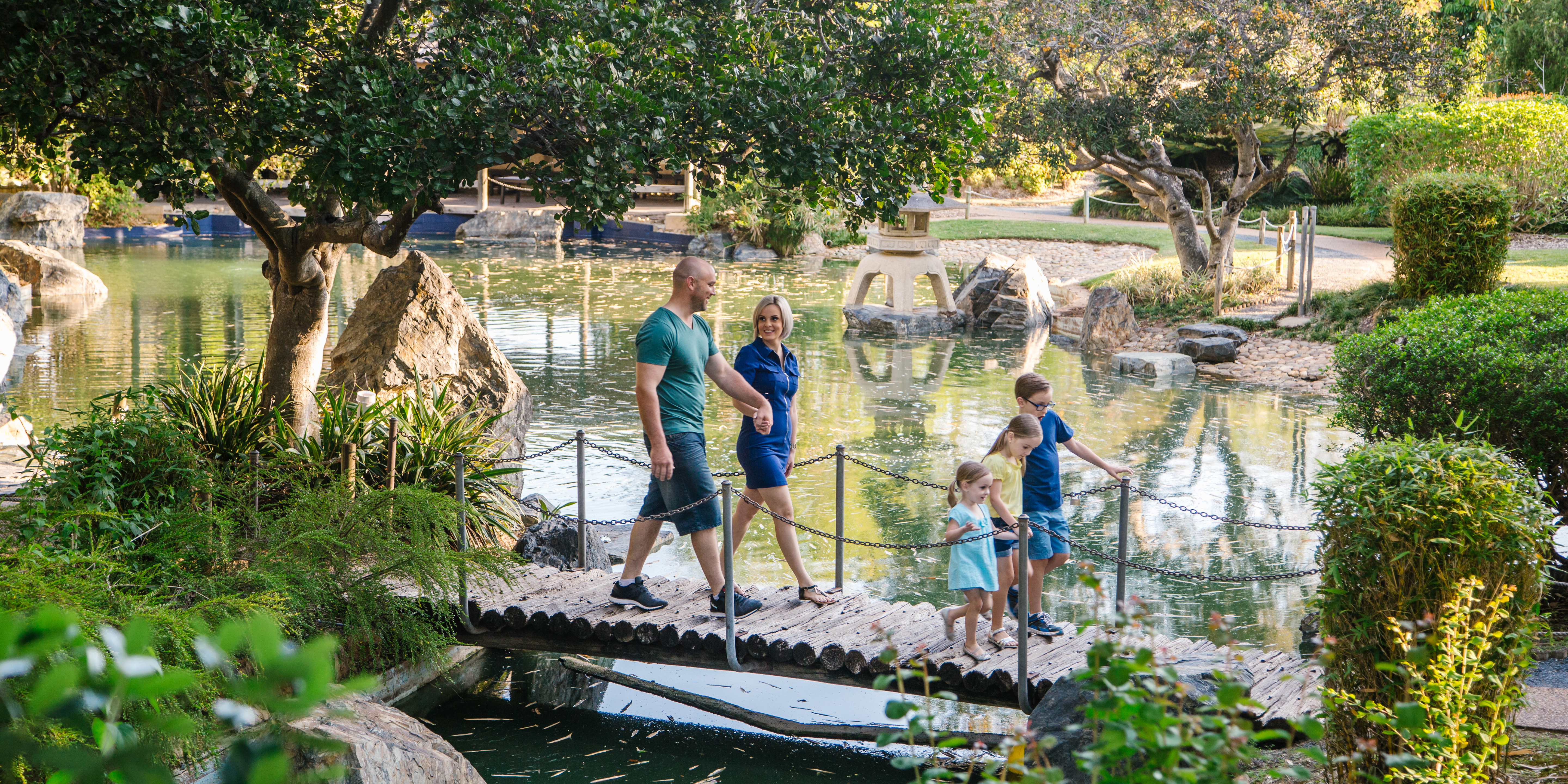 Family walking across the bridge at the Japanese Gardens