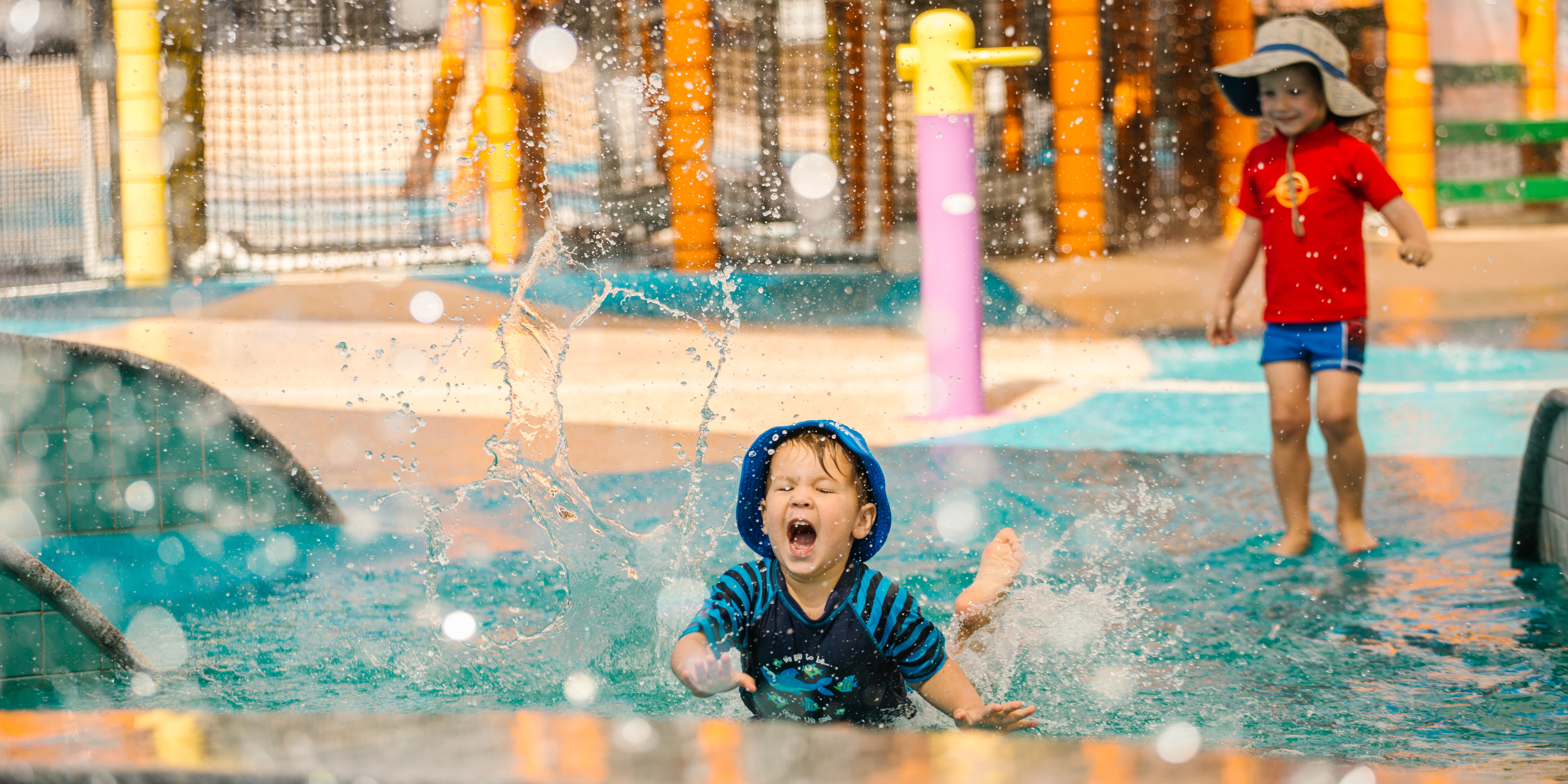 Young kids playing in a pool/wet area