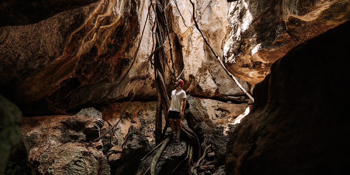 Young man wandering the magestic Capricorn Caves.