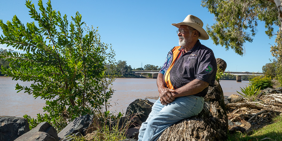 Darumbal elder sitting beside the river