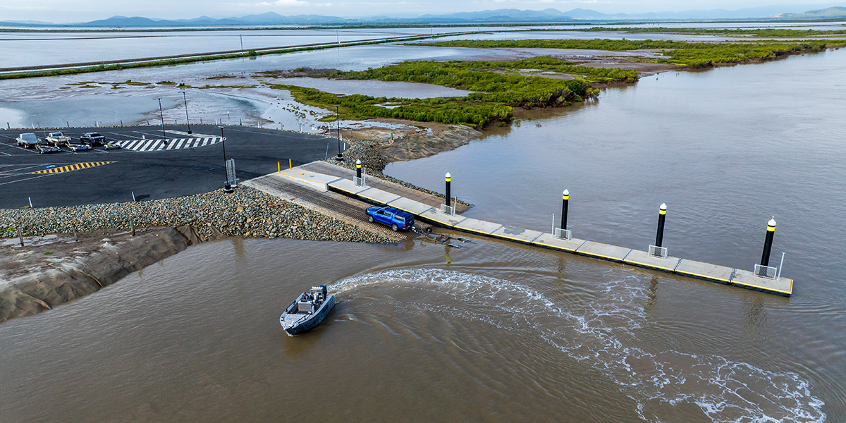Aerial shot of a boat leaving a ramp at Port Alma