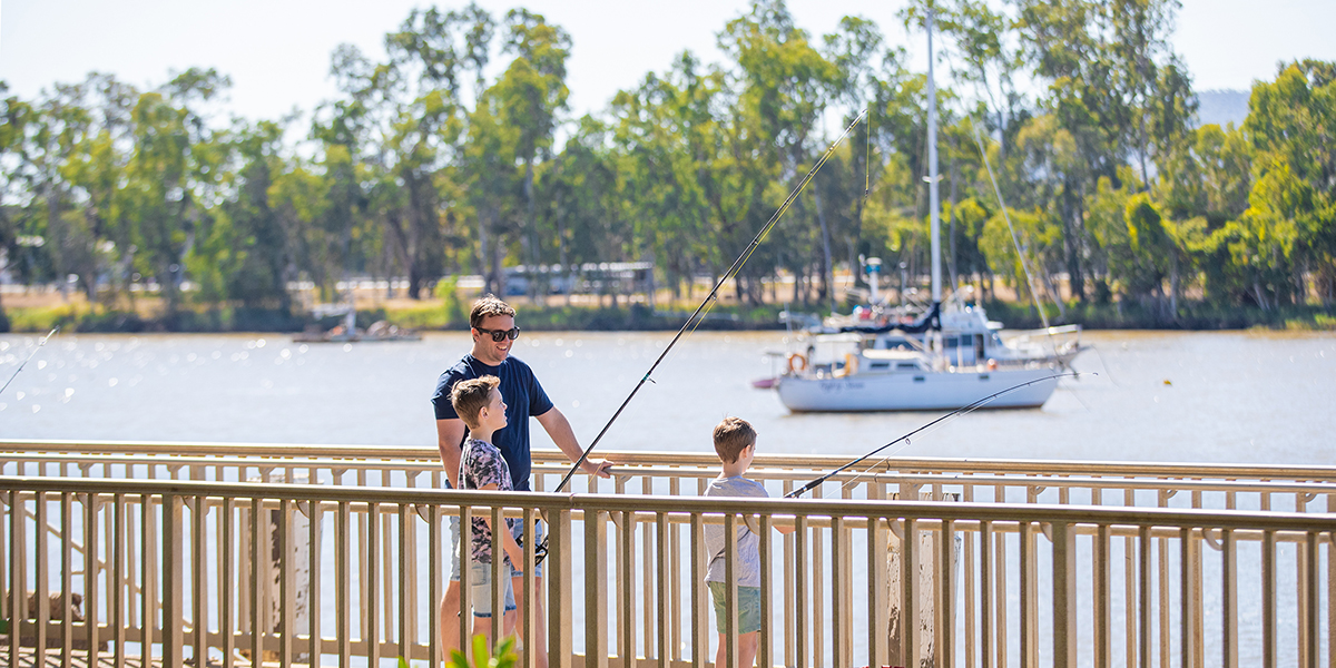 Man and young boy fishing on the bank of the Fitzroy River