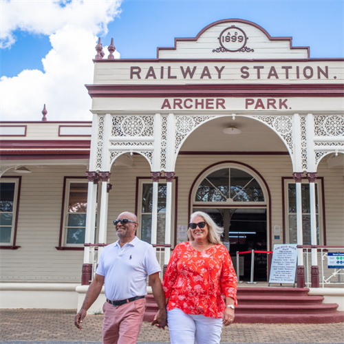 Retired couple walking out of Archer Park Rail Museum.