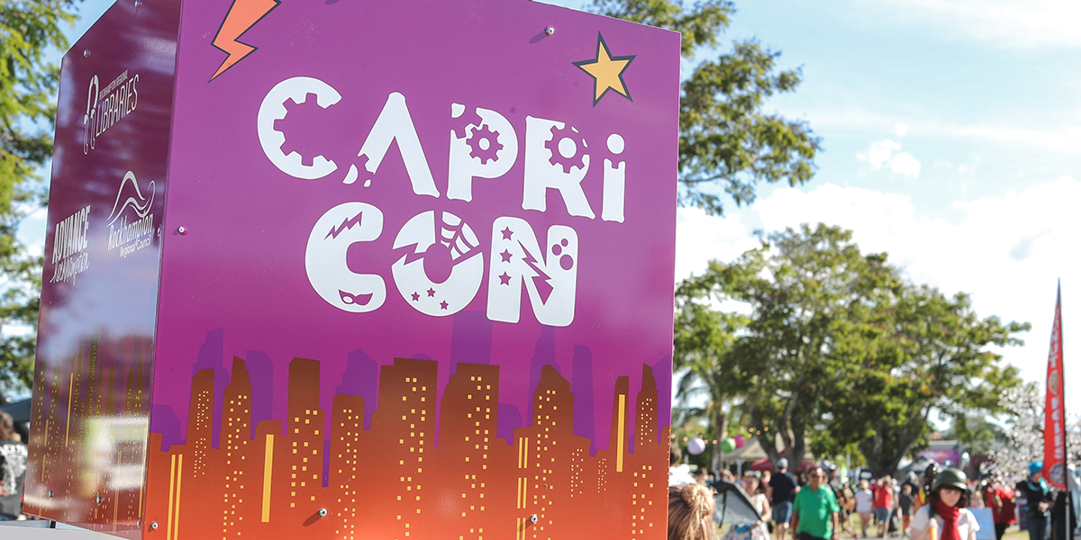 An entry sign and crown at CaprCon 2022