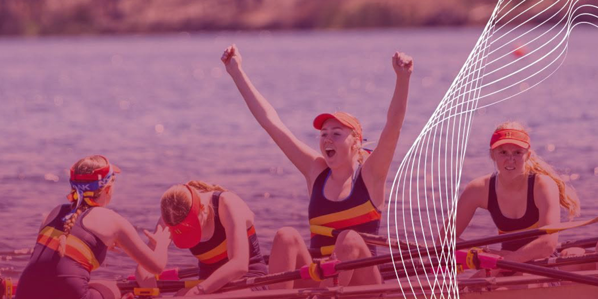 Four rowing competitors on the water in action.