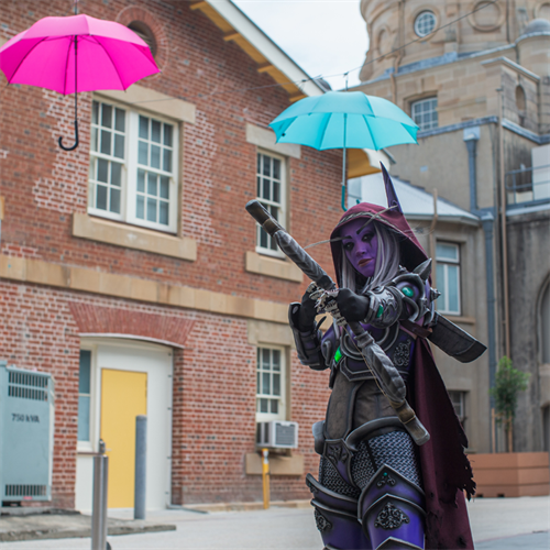 Cosplayer standing amongst heritage buildings