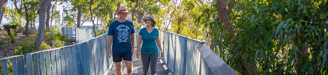 A couple walking on a treetop boardwalk