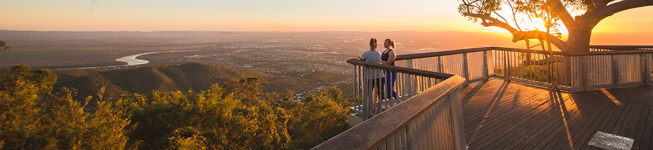 two people standing on the Nurim circuit boardwalk at sunset