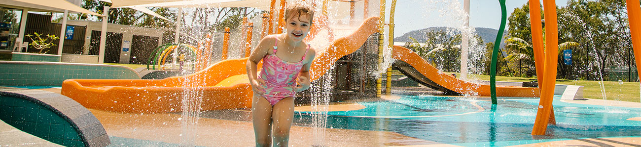 A girl playing in water playground
