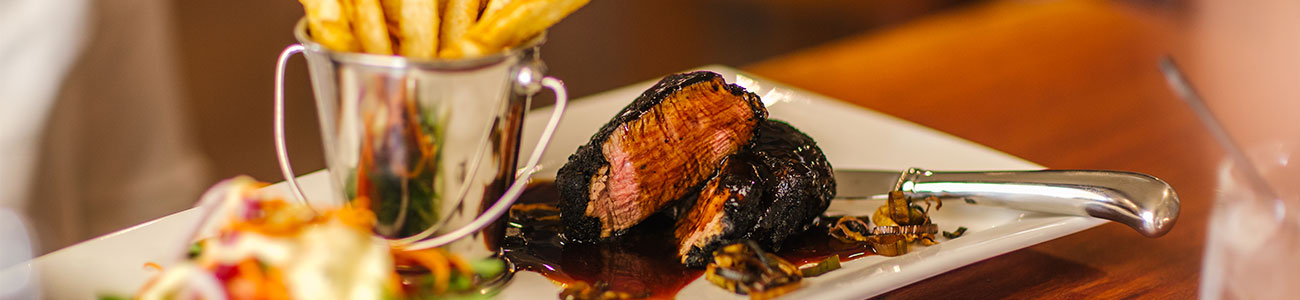 A steak on a plate in a restaurant in Rockhampton